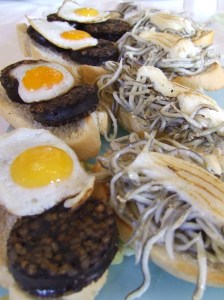 When you travel, you can try new foods such as blood sausage with quail eggs or toast with baby eel -- or not! (Photo by Cynthia Price)