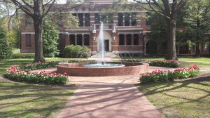 College building with fountain in front of it. 